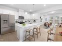 Bright kitchen features a breakfast bar, modern appliances, white cabinets, and quartz countertops at 2915 Huxley Way, Apex, NC 27502