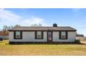 A quaint home with black accents, showcasing a well-maintained lawn and blooming flowers at 3005 Lewy Ln, Rocky Mount, NC 27801