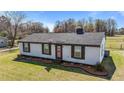Inviting one-story home featuring a manicured lawn, flower beds, and tidy landscaping at 3005 Lewy Ln, Rocky Mount, NC 27801