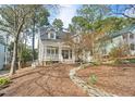 Charming home with a welcoming front porch and landscaped front yard with a winding rock border at 308 Burnt Pine Ct, Apex, NC 27502