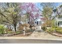 Charming home featuring a welcoming front porch, a one-car garage and well-manicured front yard at 308 Burnt Pine Ct, Apex, NC 27502