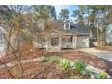 Inviting home featuring a cozy front porch with landscaped surroundings and a driveway at 308 Burnt Pine Ct, Apex, NC 27502