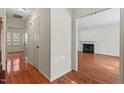 View of the open living room and hallway with hardwood floors and freshly painted white walls at 3207 Coachmans Way, Durham, NC 27705