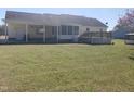 Spacious backyard featuring a covered patio, deck and a well-maintained lawn at 3226 Powhatan Rd, Clayton, NC 27527