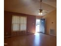 Inviting living room features laminate flooring, large windows and a ceiling fan at 3226 Powhatan Rd, Clayton, NC 27527