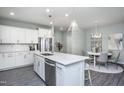 Bright, modern kitchen features a spacious island, stainless steel appliances, and a dining area at 373 Fosterton Cottage Way, Raleigh, NC 27603