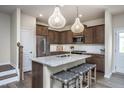 Modern kitchen featuring stainless steel appliances, granite countertops, and a stylish island with seating at 4004 Kidd Pl, Durham, NC 27703