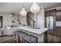 Inviting living space featuring kitchen island seating, access to stairs, stainless steel appliances and neutral tones at 4004 Kidd Pl, Durham, NC 27703