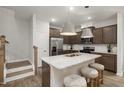 Modern kitchen with granite countertops, stainless steel appliances, and a central island with seating at 4006 Kidd Pl, Durham, NC 27703