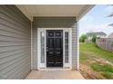 Classic black front door with sidelights and white trim, inviting entrance at 4038 Patriot Ridge Ct, Raleigh, NC 27610