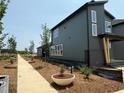 Home exterior showing mulched plantings and a gray sidewalk running along the home's length at 50 Rainfall Dr, Pittsboro, NC 27312