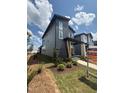 Modern two-story home with landscaping, a gray exterior, and an 'Available' sign in the front yard at 50 Rainfall Dr, Pittsboro, NC 27312