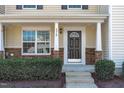 Inviting front entrance featuring a decorative door with stone pillar accents at 5210 Blue Lagoon Ln, Raleigh, NC 27610