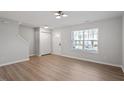 Bright and airy living room with hardwood floors and a large window allowing plenty of natural light at 5210 Blue Lagoon Ln, Raleigh, NC 27610