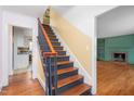 View of foyer with hardwood floors, a staircase, and views of the living room and kitchen at 603 W Main St, Haw River, NC 27258