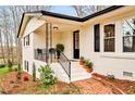 Inviting front porch featuring elegant railing, comfortable seating, and tasteful landscaping, enhancing curb appeal at 605 Canterbury Rd, Sanford, NC 27330