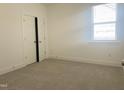 Cozy bedroom with plush carpeting, a window for natural light, and a spacious closet at 63 Tee Time Ter, Benson, NC 27504
