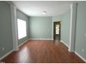Bright and airy living room featuring wood-look flooring and column accents at 701 Marjam Ln, Fuquay Varina, NC 27526