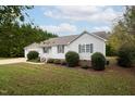 View of a one-story home with landscaped yard and side-entry garage at 7329 Blannie Farms, Willow Springs, NC 27592
