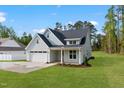 This single Gathering home boasts a large yard, two car garage, and welcoming porch at 8487 Old Us 421, Lillington, NC 27546