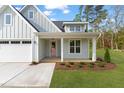Beautiful home featuring a charming front porch and landscaped yard at 8487 Old Us 421, Lillington, NC 27546
