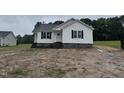 A single story new construction home with black shutters and stone foundation at 9600 Stallings Rd, Spring Hope, NC 27882