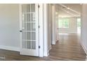 Bright entryway features a glass French door that leads to an open-concept layout with hardwood floors at 98 Tee Time Ter, Benson, NC 27504
