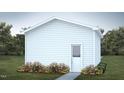 White detached garage with a single entry door, surrounded by vibrant flowers and lush greenery at 101 Parkland Dr, Pittsboro, NC 27312