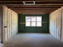 Unfinished room featuring window, ZIP System sheathing, and insulation, awaiting customization at 101 Parkland Dr, Pittsboro, NC 27312