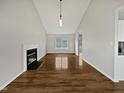 Bright, airy living room with a fireplace, vaulted ceiling, and light wood floors at 108 New Castle Ct, Youngsville, NC 27596