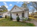 A quaint one-story home featuring a gable roof, two windows, and a porch with metal support posts at 1103 Gaston St, Smithfield, NC 27577