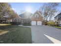 Charming brick home with well-kept lawn and a two-car garage, bathed in sunlight at 1301 Merrington Cir, Raleigh, NC 27615