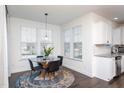 Bright breakfast nook featuring a pendant light, round table, and views through sunlit windows at 140 Ashberry Ln, Franklinton, NC 27525