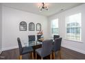 Elegant dining room with modern light fixture, glass table, and decorative wall mirrors at 140 Ashberry Ln, Franklinton, NC 27525