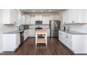 Stylish kitchen featuring white cabinets, stainless steel appliances, and granite countertops at 140 Ashberry Ln, Franklinton, NC 27525