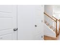 Bright entryway with coat closet and staircase featuring wood railing at 18 Twin Birch Dr, Angier, NC 27501