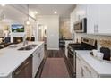 Contemporary kitchen offers white cabinets, modern appliances, and an island, seamlessly connecting to living spaces at 210 Shingle Oak Rd, Wake Forest, NC 27587