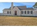 Attractive exterior showcasing gray brick, a black roof, and neat black shutters on a sunny day at 2120 Cokey Rd, Rocky Mount, NC 27801