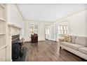 Inviting living room with hardwood floors, a cozy couch, an arched doorway, and a traditional fireplace at 2120 Cokey Rd, Rocky Mount, NC 27801