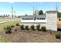 Entrance sign for Vaughan Farms community with landscaping, brick accents, and clear signage at 22 Twin Birch Dr, Angier, NC 27501