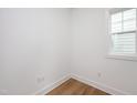 A minimalist bedroom with wood flooring, white walls, baseboard and window trim at 280 Beacon Dr, Pittsboro, NC 27312