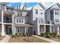 Attractive townhome exterior with varied textures, complemented by a well-maintained lawn at 2904 Great Lawn Rd, Apex, NC 27502