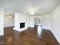 Spacious living room with hardwood floors and a cozy brick fireplace at 300 Perry St, Rolesville, NC 27571