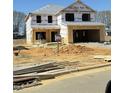 New home under construction featuring a two car garage with a worker onsite at 316 Hopewell Branch Ct, Smithfield, NC 27577