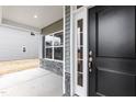 View of the front entryway with stone accents and a black door with sidelight and white trim at 316 Hopewell Branch Ct, Smithfield, NC 27577
