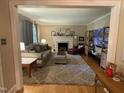 Comfortable living room with a fireplace, soft lighting, and stylish decor at 321 Willowood Dr, Henderson, NC 27536