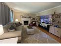 Cozy living room featuring a fireplace, plush seating, and built-in shelving at 321 Willowood Dr, Henderson, NC 27536