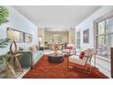 Inviting living room featuring stylish furniture, large windows, and an open view to the dining area at 3613 Hope Valley Rd, Durham, NC 27707