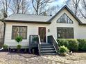 Inviting front exterior featuring lush landscaping, a quaint entryway, and eye-catching architectural design at 3900 Marklyn Pl, Hillsborough, NC 27278