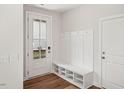 Bright entryway with a bench, shoe storage, coat hooks, and a glass paneled door at 4511 Mint Leaf Ln, Raleigh, NC 27612